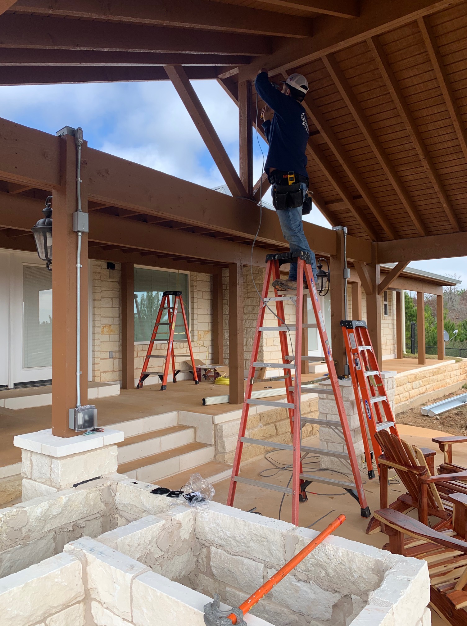 Easton Electric electrician installing wiring on a covered patio
