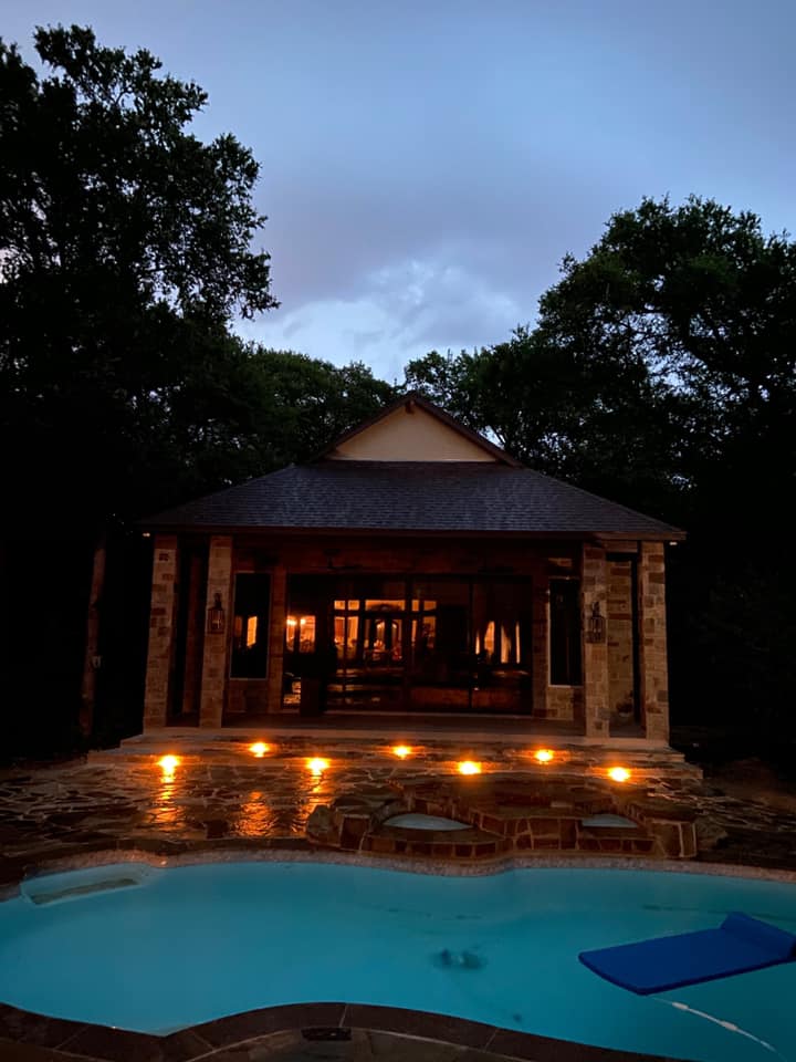 Pool house with exterior and landscape lighting